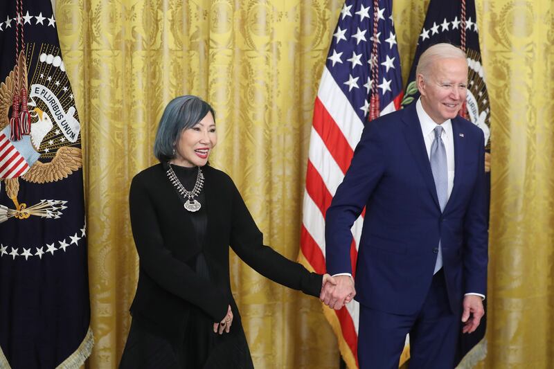 Mr Biden presents bestselling author Amy Tan with a National Humanities Medal. EPA