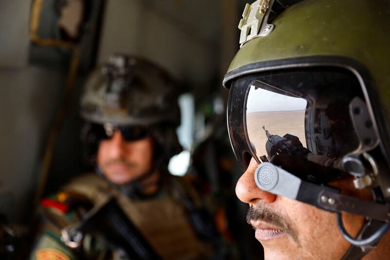 Iraqi Special Forces troops sit inside a helicopter during the "Solid Will" military operation against ISIS militants in the desert of Anbar, Iraq.