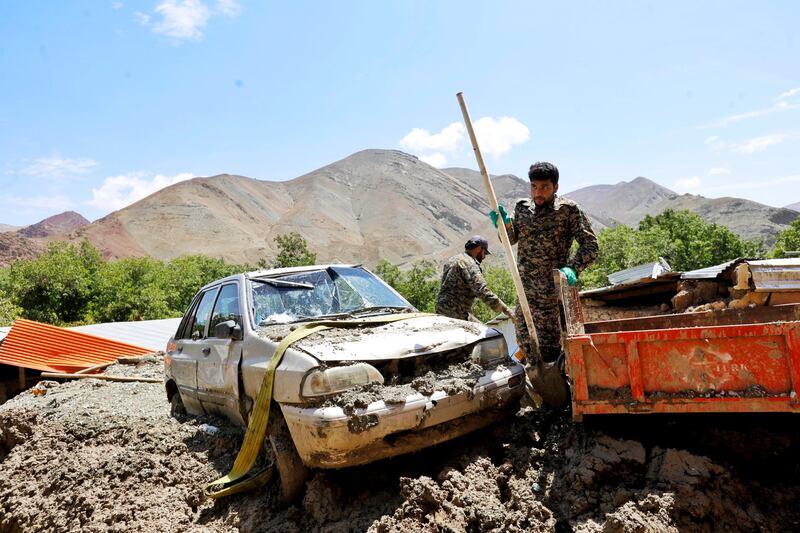 Rescue workers in Firuzkuh, Iran. Reports say flash floods washed cars and their passengers away. EPA