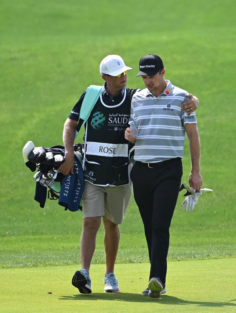 England's Justin Rose and his caddie walking down the 9th fairway. Rose carded an opening round 68. Getty