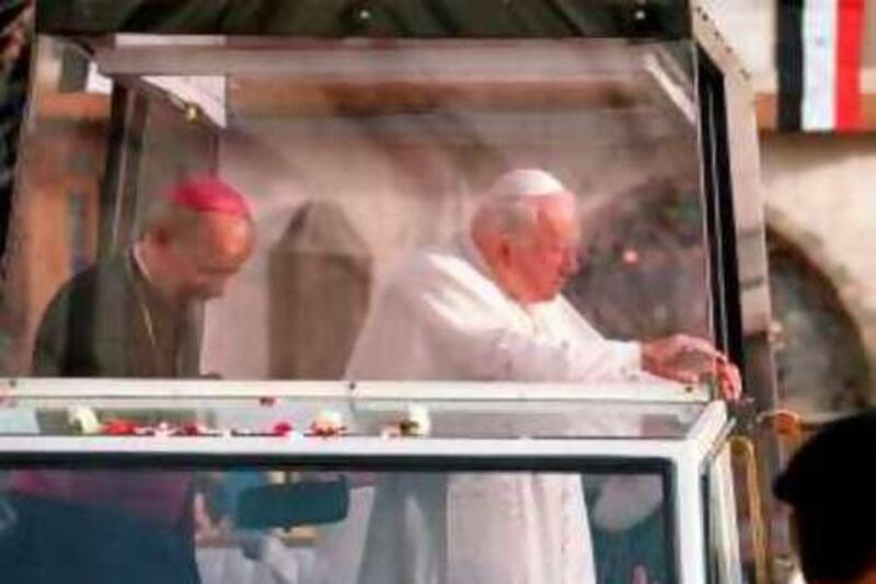 388889 05: Pope John Paul ll waves to crowds of people May 5, 2001 as his car passes through an old street in Damascus, Syria. (Photo by Salah Malkawi/Newsmakers)