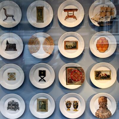 Sotheby's used imprinted plates in its window to depict the products in an antiques auction