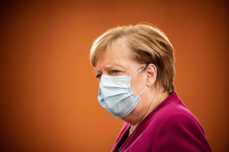 German Chancellor Angela Merkel wearing a face mask frowns as she arrives to attend the weekly cabinet meeting of the German government at the Chancellery in Berlin, on October 14, 2020.  / AFP / POOL / Michael Kappeler
