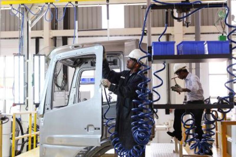 An employee works on the body of a BharatBenz truck inside Daimler's new factory in Oragadam, in the Kancheepuram district of the southern Indian state of Tamil Nadu April 18, 2012. Daimler has been assembling high-end trucks in India for years, all bearing its iconic Mercedes-Benz logo, but recently launched its cut-price BharatBenz line, part of a trend that is seeing global manufacturers localise their products to compete in India's high-volume and cost-conscious mass market. Picture taken April 18, 2012. To match feature INDIA-MANUFACTURING/   REUTERS/Babu (INDIA - Tags: BUSINESS TRANSPORT EMPLOYMENT INDUSTRIAL) *** Local Caption ***  DEL102_INDIA-MANUFA_0509_11.JPG