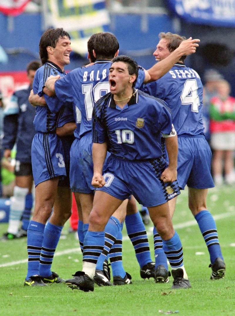 Argentina's World Cup soccer team captain Diego Maradona (C) yells out as he and his teammates celebrate after Argentina scored their second goal in their 21 June 1994 World Cup match against Greece at oxboro Stadium near Boston. Atrear are, from left to right, Jose Chamot, Abel Balbo and Roberto Sensini. (Photo by DANIEL GARCIA / AFP)