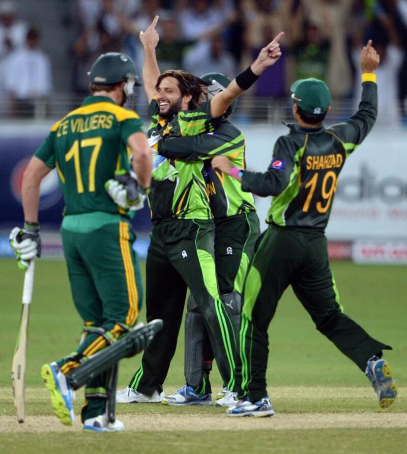 Pakistan's Shahid Afridi, centre, is surrounded by his teammates after taking South African cricketer Faf du Plessis (unseen) out for lbw during the second day-night international against South Africa in Dubai Cricket Stadium in Dubai on November 1. Asif Hassan / AFP 