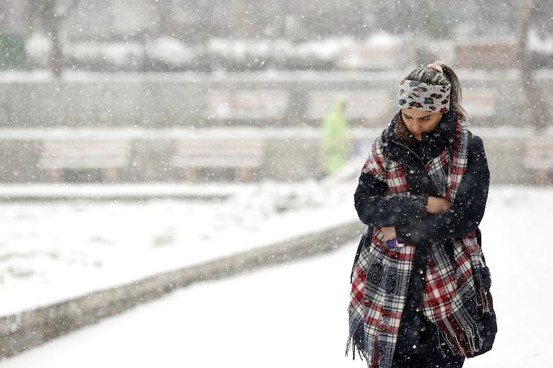 A woman braces herself against the cold and heavy snow in Tehran. Noon temperatures in the Iranian capital were around 3°C on January 16. EPA