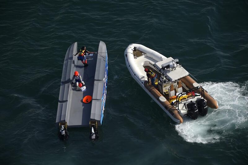 A rescue boat is seen beside Brett Luhrmann and Pal Virik Nilsen of Team Australia. Mike Hewitt / Getty Images
