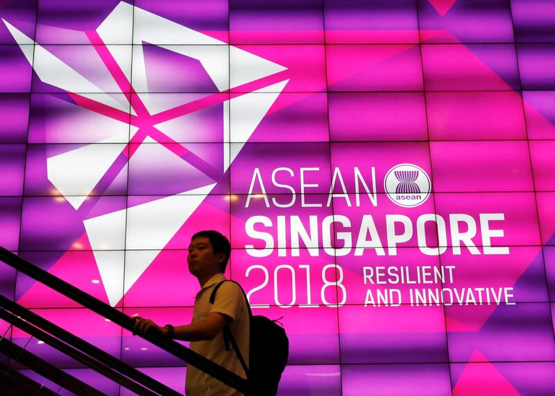 A man passes the ASEAN Summit signage at Suntec Convention Centre in Singapore, November 11, 2018. REUTERS/Edgar Su