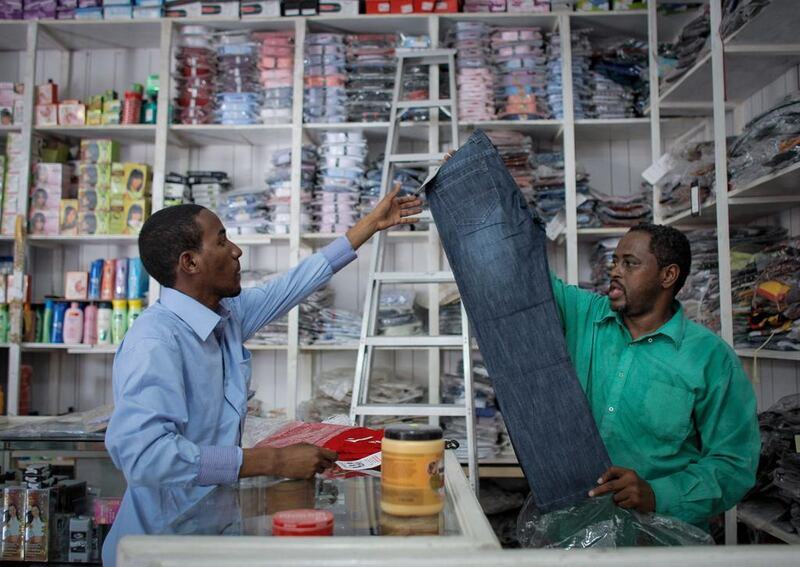 A shopkeeper serves a customer in the Somali capital Mogadishu, where commerce is slowly returning to normal. (Stuart Price /  EPA)