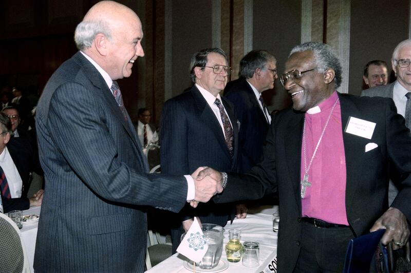 South Africa's former president Frederik Willem de Klerk shakes hands with Tutu at signing of the historic National Peace accord in 1991. AFP