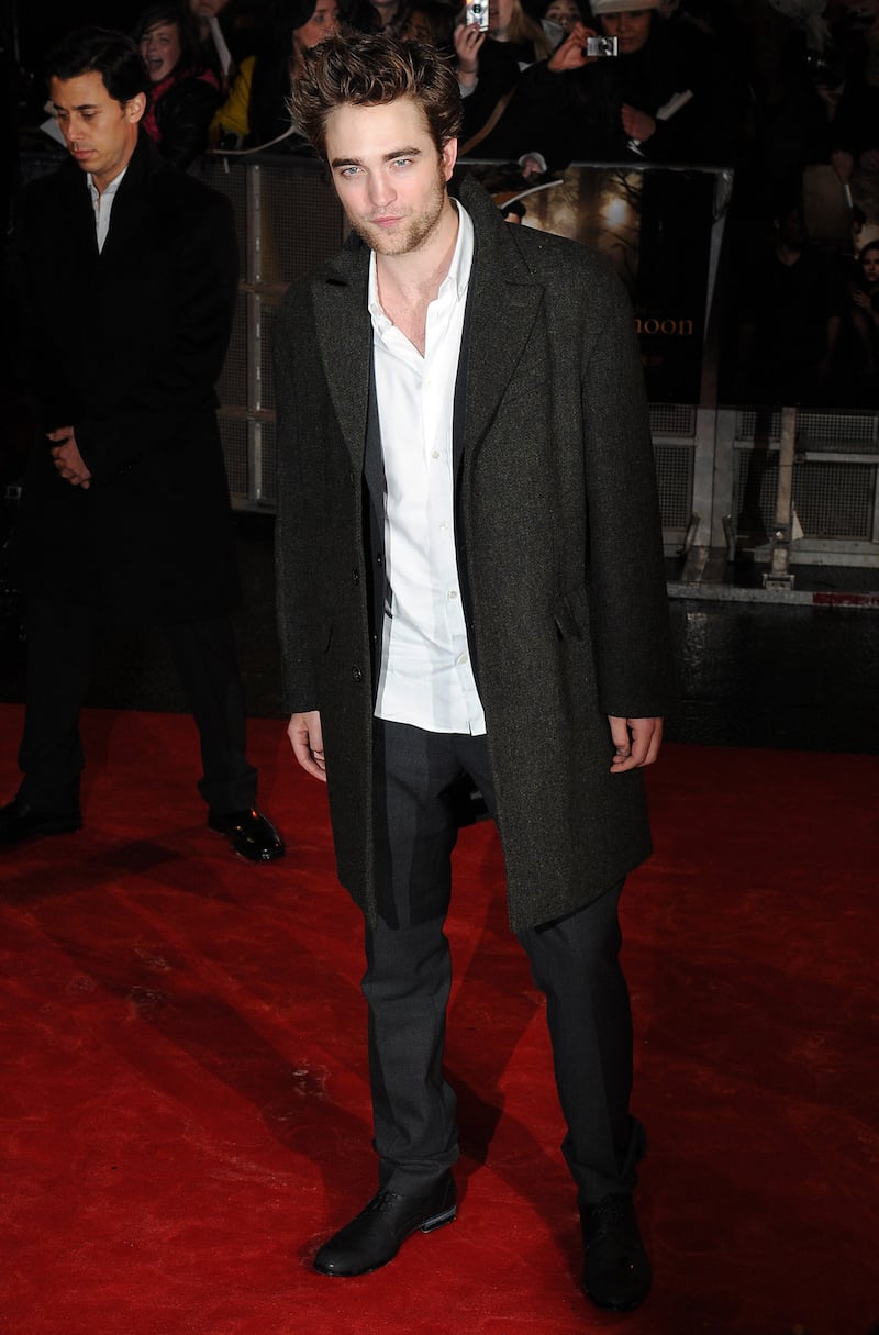 Robert Pattinson, in a grey wool coat and suit, attends a 'Twilight Saga: New Moon' UK fan event in London on November 11, 2009. Getty Images