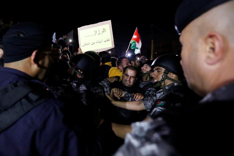 Demonstrators take part in a protest against tax hikes in Amman, Jordan November 30, 2018. The sign reads "al-Razzaz is liar more than al-Mulqi". REUTERS/Muhammad Hamed