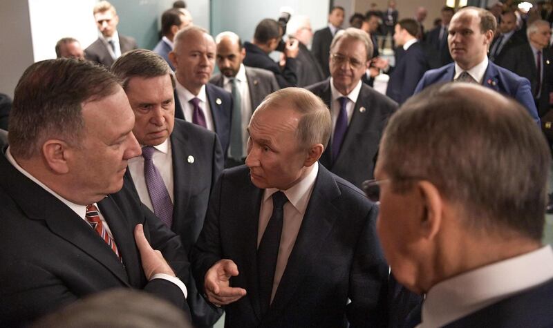 US Secretary of State Mike Pompeo (L) and Russian President Vladimir Putin talk on the sidelides of a Peace summit on Libya in Berlin.   AFP