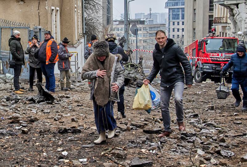 Locals evacuate from a damaged residential building following a missile strike, in Kharkiv, northeastern Ukraine. EPA