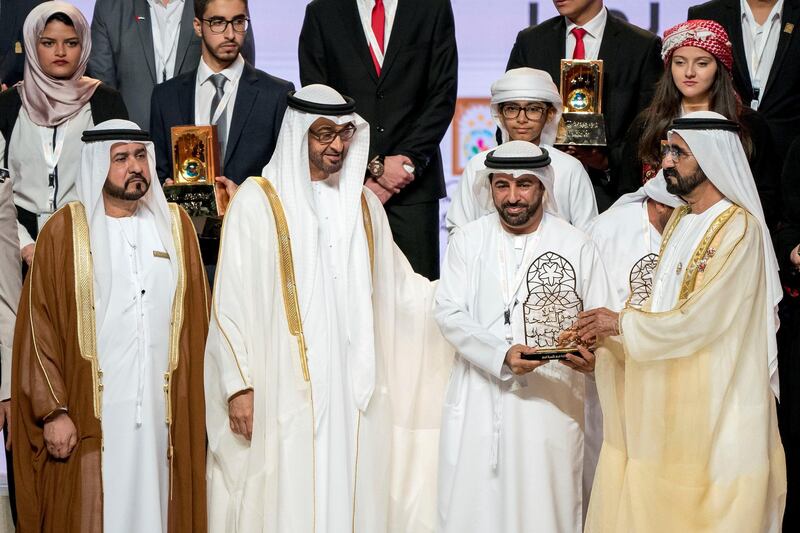 ABU DHABI, UNITED ARAB EMIRATES - November 22, 2017: HH Sheikh Mohamed bin Zayed Al Nahyan, Crown Prince of Abu Dhabi and Deputy Supreme Commander of the UAE Armed Forces (3rd R) and HH Sheikh Mohamed bin Rashid Al Maktoum, Vice-President, Prime Minister of the UAE, Ruler of Dubai and Minister of Defence (R), present award to a winner during the HH Sheikha Fatima bint Mubarak Awards for Excellence and Social Creativity, at Emirates Palace. Seen with HE Ali bin Salem Al Kaabi Director of the Office of the Minister of Presidential Affairs and Chairman of the Board of Trustees of the Family Development Foundation (L).

( Rashed Al Mansoori / Crown Prince Court - Abu Dhabi )
---