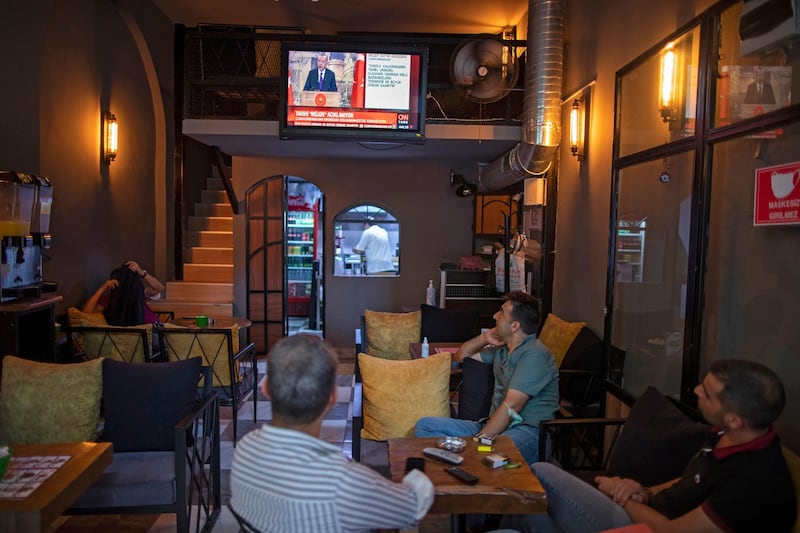 People watch the at a cafe TV while Turkish President Recep Tayyip Erdogan announces the biggest natural gas discovery in history in Istanbul, Turkey.  EPA