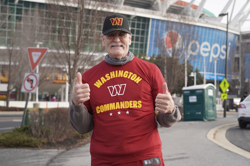 Stan Walker, 70, dons the Washington Commanders hat and t-shirt he purchased at the team gift shop. Willy Lowry / The National.