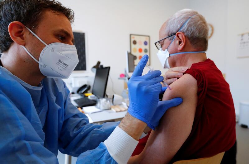 A man receives a dose of the AstraZeneca coronavirus disease (COVID-19) vaccine by general practitioner Kerem Erekul in a doctors practice in Berlin, Germany, April 10, 2021.     REUTERS/Fabrizio Bensch