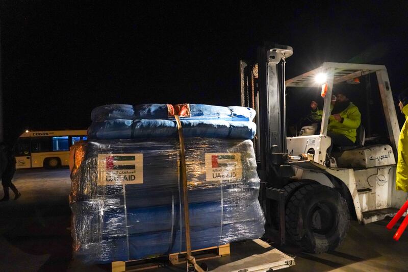 Tents and other camping materials being moved from the plane