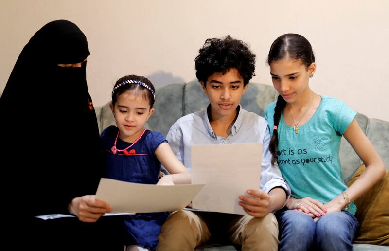 Omar sits at home with his family in Alexandria, Egypt.