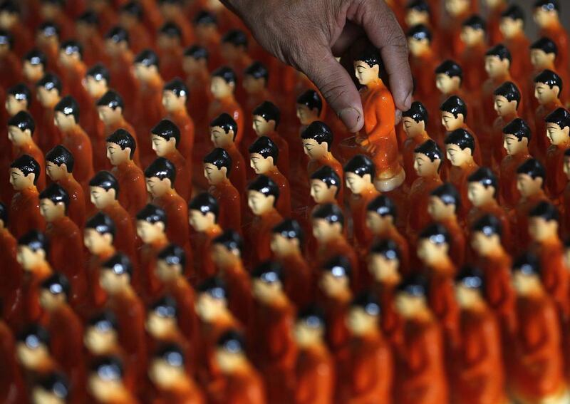 A man picks up statues of Buddha one by one, as he packs them for sale at a workshop ahead of Vesak Day celebrations in Colombo. Vesak Day, which is celebrated on May 14 and 15 in Sri Lanka, commemorates the birth, enlightenment and death of Buddha. Dinuka Liyanawatte/ Reuters