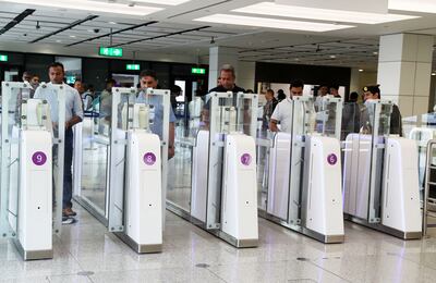 Passengers using the smart gates at Terminal 1 of Dubai International Airport. Pawan Singh/The National
