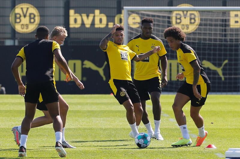 Borussia Dortmund's Jadon Sancho, cnetre, and Axel Witsel, right, during training. Reuters