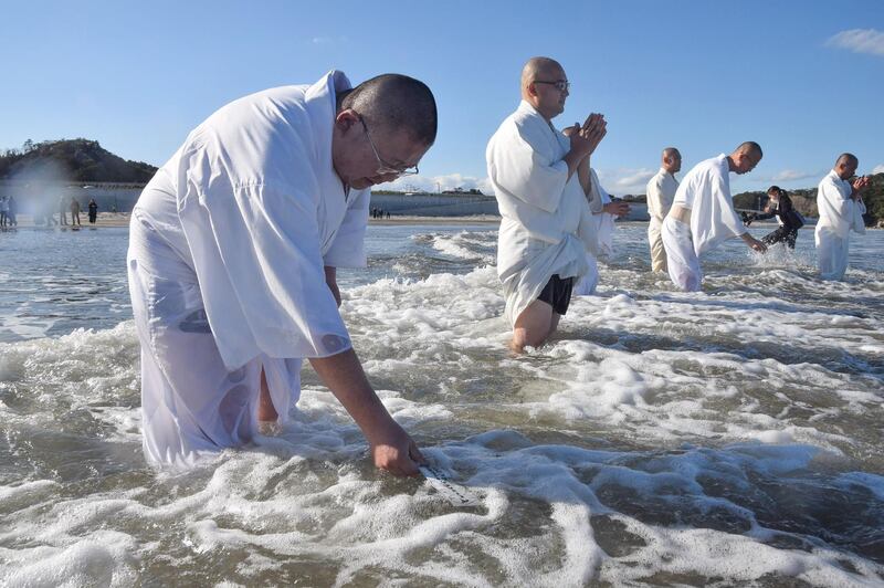 Monks pray for victims of the 2011 earthquake and tsunami disaster during a memorial service on the coast in Iwaki, Fukushima prefecture, Japan.  AFP