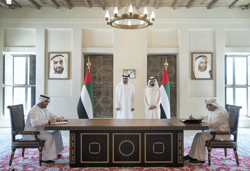 DUBAI, UNITED ARAB EMIRATES - March 20, 2018: HH Sheikh Mohamed bin Zayed Al Nahyan Crown Prince of Abu Dhabi Deputy Supreme Commander of the UAE Armed Forces (back L) and HH Sheikh Mohamed bin Rashid Al Maktoum, Vice-President, Prime Minister of the  UAE, Ruler of Dubai and Minister of Defence (back R), witness the signing of a joint venture agreement between Aldar and Emaar. Seen signing are HE Mohamed Khalifa Al Mubarak, Chairman of the Department of Culture and Tourism and Abu Dhabi Executive Council Member (L) and HE Mohamed Al Abbar, Founder and Chairman of Emaar Properties and Board Member of Eagle Hills (R), in Shindagha Heritage District. 

( Mohamed Al Hammadi / Crown Prince Court - Abu Dhabi )
---