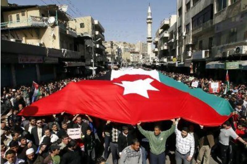 Thousands of Jordanians, including Islamists, trade unionists and leftists, hold a giant national flag during a demonstration earlier this month to demand 'regime reforms'.