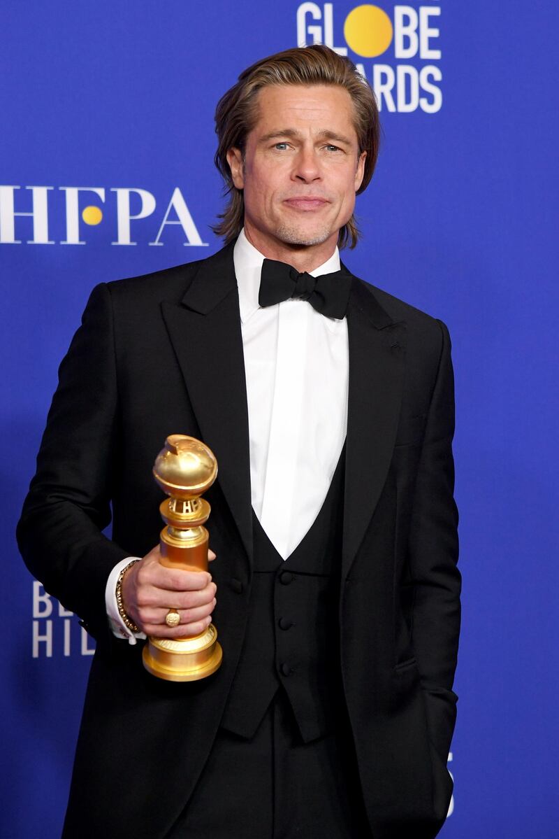 Brad Pitt poses with his award for Best Performance by an Actor in Supporting Role in Any Motion Picture for his role in 'Once Upon a Time ... in Hollywood' during the 77th annual Golden Globe Awards on January 5, 2020, at The Beverly Hilton hotel in Beverly Hills, California. AFP