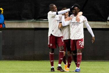 Arsenal's Folarin Balogun, right, is congratulated for scoring to take the score to 0-3, by Cedric and Nicolas Pepe, left, during the Europa League Group stage Group B, soccer match between Molde and Arsenal at Aker Stadium in Molde, Norway, Thursday Nov. 26, 2020. (Svein Ove Ekornesvag / NTB via AP)