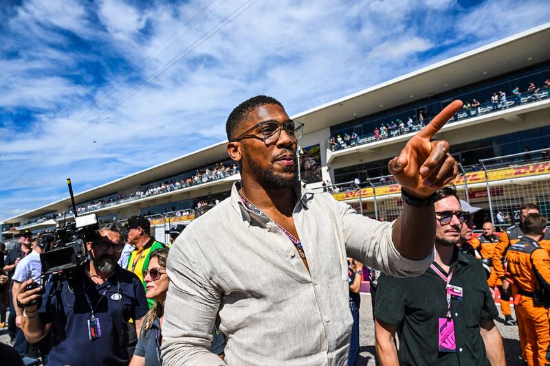 British boxer Anthony Joshua walks on the grid. AFP