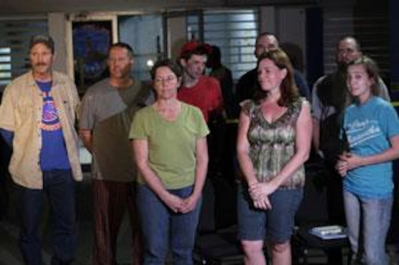 From left to right, Americans Steve McMullin, Jim Allen, Carla Thompson, Silas Thompson, Paul Thompson, Laura Silsby, Drew Culberth and Nicole Lankford at police headquarters in the Port-au-Prince international airport.