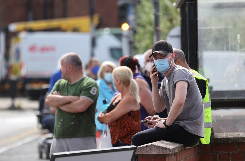 People wait in line at a testing centre near the Crown and Anchor pub following a spike in cases of the coronavirus disease (COVID-19) to visitors of the pub in Stone, Britain, July 30, 2020. REUTERS/Carl Recine