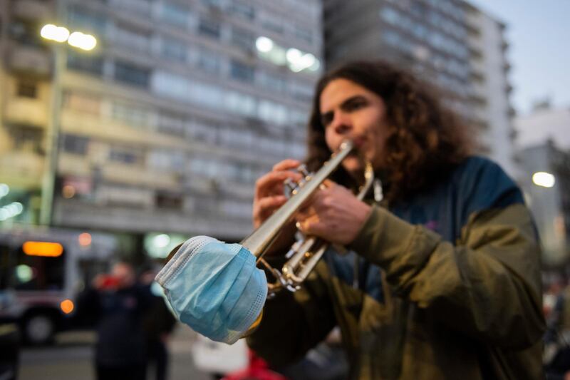 A trumpeter takes part in a protest by musicians who are asking to be allowed to play outdoors again and for coronavirus subsidies, in downtown Montevideo, Uruguay. AP Photo