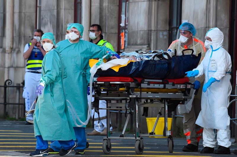 Medical staff members gather before carrying patients infected with the novel coronavirus as they arrive at the Saint-Jean train station in Bordeaux, southwestern France. AFP