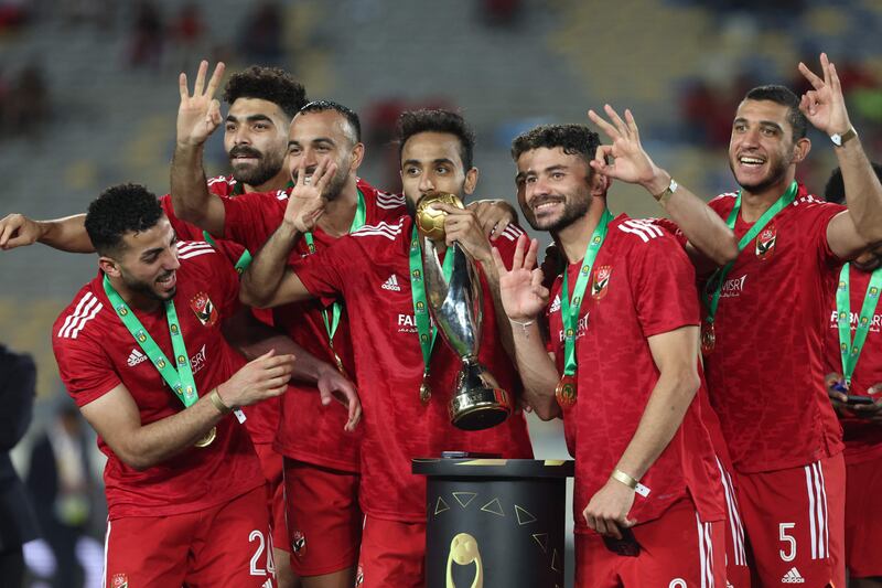 Al Ahly players celebrate with the CAF Champions League trophy and their medals. AFP