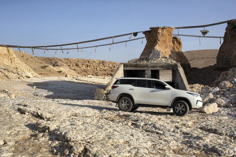 Locals are using the riverbed while the bridge is damaged. This photo shows the height of the bridge. Antony Hansen for The National