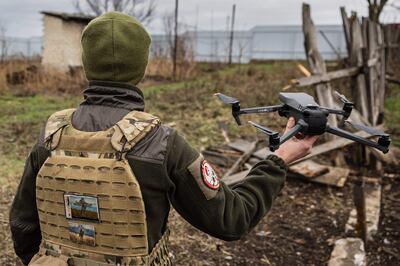 A Ukrainian serviceman about to launch a drone on the outskirts of Bakhmut, eastern Ukraine. AFP