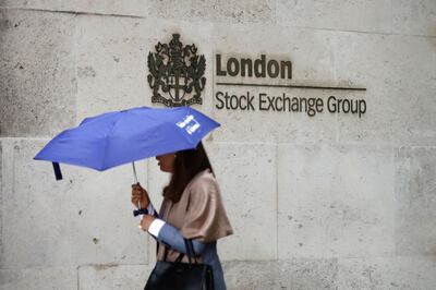 (FILES) This file photo taken on August 09, 2017 shows a commuter walking past the London Stock Exchange in the City of London on August 9, 2017. 
London Stock Exchange Group shareholders are to vote on whether to hasten chairman Donald Brydon's exit following investor anger at the departure of chief executive Xavier Rolet, the LSEG announced December 1, 2017. / AFP PHOTO / Tolga AKMEN