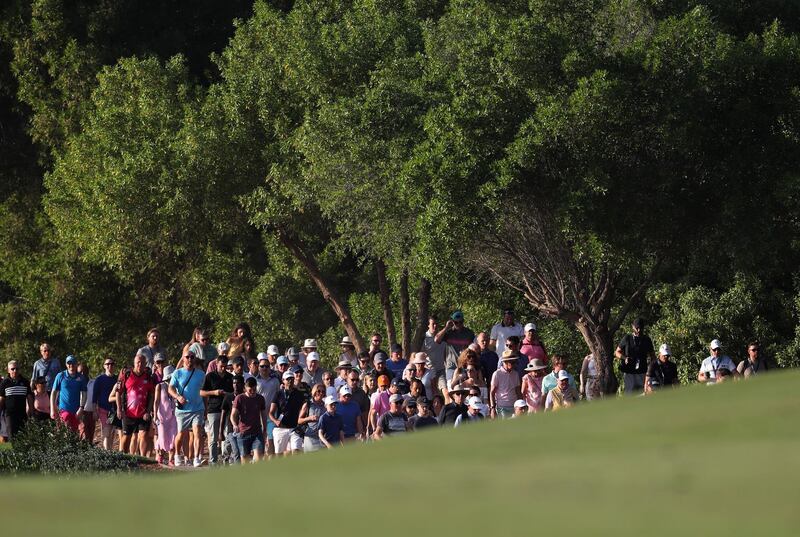 Fans walk along the 16th hole during the third round of the DP World Tour Championship golf tournament in Dubai, United Arab Emirates, Saturday, Nov. 23, 2019. (AP Photo/Kamran Jebreili)