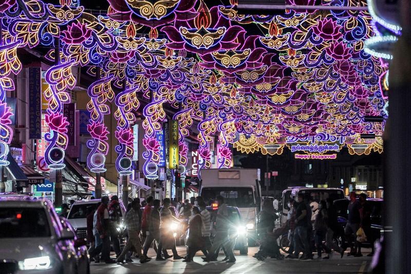 Pedestrians cross a traffic junction under Deepavali decorations in the Little India cultural district of Singapore.  EPA