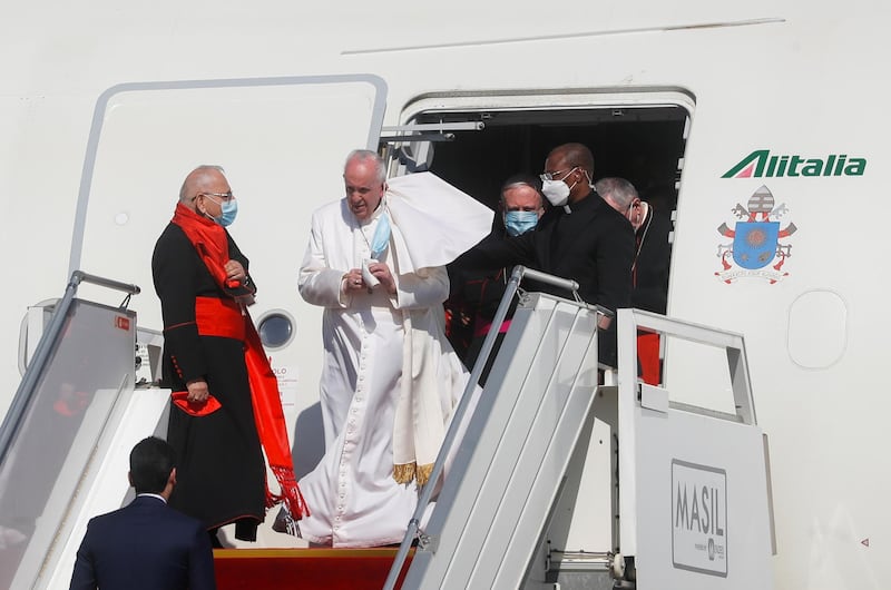 Pope Francis disembarks a plane as he arrives at Baghdad International Airport. Reuters