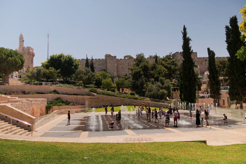 Children play in a water fountain near the walls of Jerusalem's Old City. Reuters