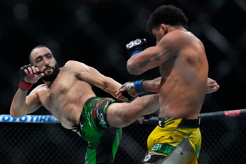 Belal Muhammad, left, kicks Brazil's Gilbert Burns during the first round of a welterweight bout at the UFC 288 mixed martial arts event Saturday, May 6, 2023, in Newark, N. J.  Muhammad won the fight.  (AP Photo / Frank Franklin II)