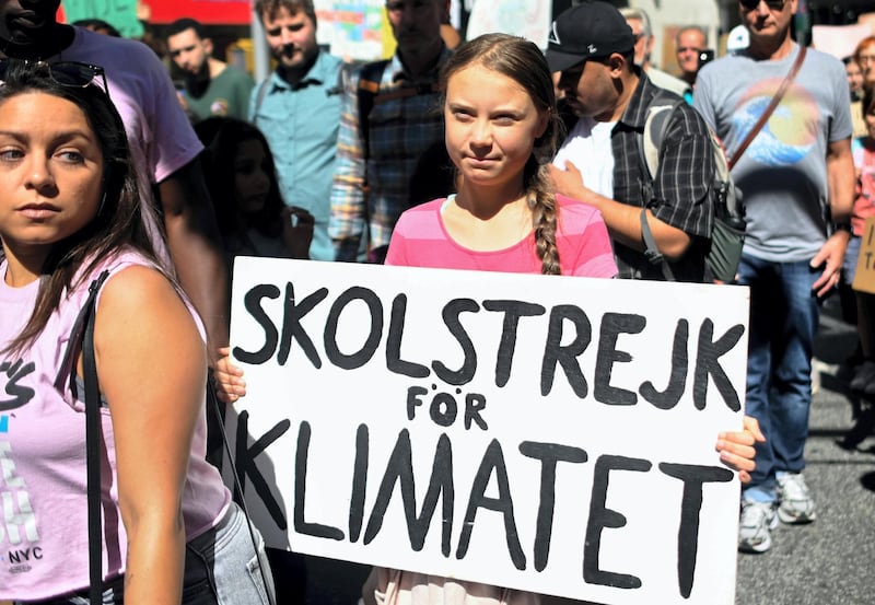 Teen activist Greta Thunberg walks during the Global Climate Strike march on September 20, 2019 in New York City. - Crowds of children skipped school to join a global strike against climate change, heeding the rallying cry of teen activist Greta Thunberg and demanding adults act to stop environmental disaster. It was expected to be the biggest protest ever against the threat posed to the planet by climate change. (Photo by Johannes EISELE / AFP)