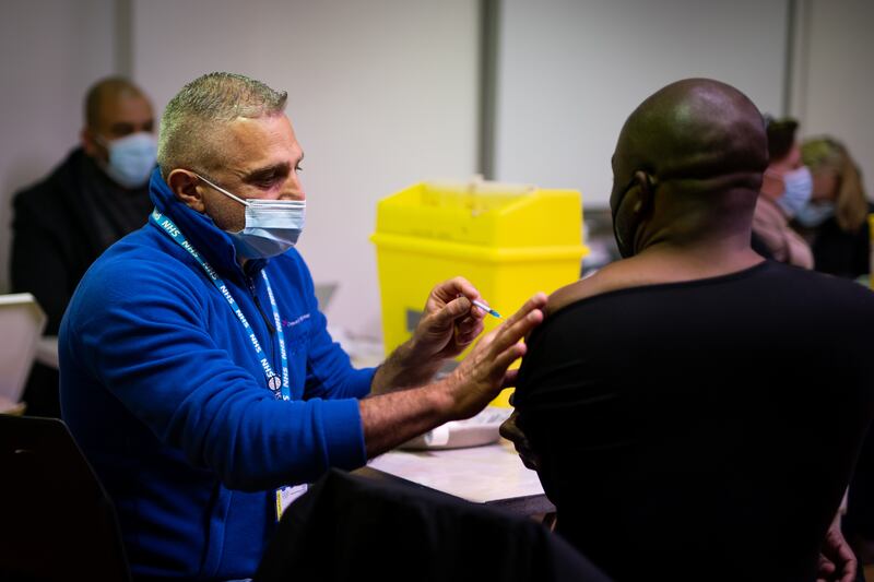 A man receives a Covid booster vaccine at the Abbey vaccination centre in Westminster, London. PA