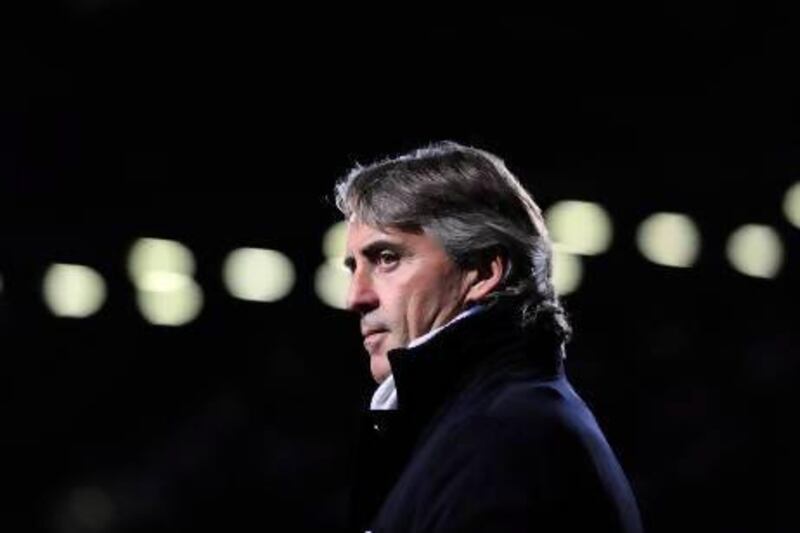 Roberto Mancini can be charming and funny, and is idolised by the Manchester City fans, although, to his players, he can seem a cold figure unafraid to lambast them in public. Glyn Kirk / AFP